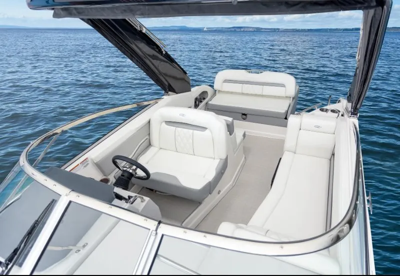 Slide: The Image of 2023 Regal 28 Express boat interior with white seating on open water. - 3