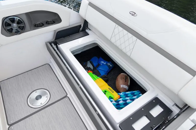 Slide: The Image of 2023 Regal 28 Express boat storage compartment with toys and accessories. - 7