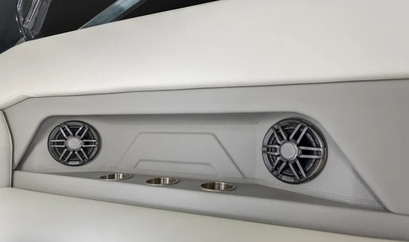Slide: The Image of 2023 Regal 28 Express boat interior with built-in speakers and cup holders. - 8