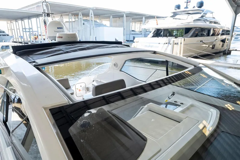 Slide: The Image of 2017 Azimut Atlantis 43 yacht with open sunroof docked at marina. - 2