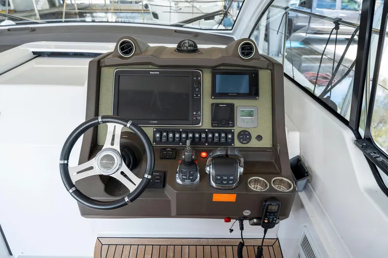 Slide: The Image of 2017 Azimut Atlantis 43 yacht helm with advanced navigation controls and steering wheel. - 3