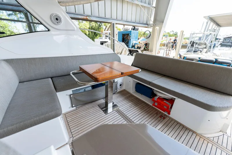 Slide: The Image of 2017 Azimut Atlantis 43 yacht interior seating area with wooden table. - 5