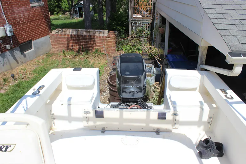 Slide: The Image of 1996 Parker 2110 Walkaround boat with outboard motor in backyard. - 18