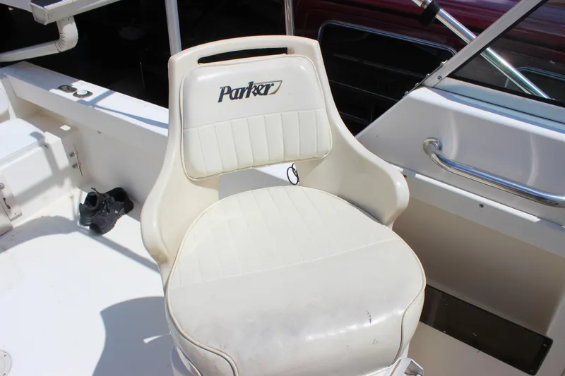 Slide: The Image of Parker 2110 Walkaround 1996 boat seat with white upholstery and Parker logo. - 19