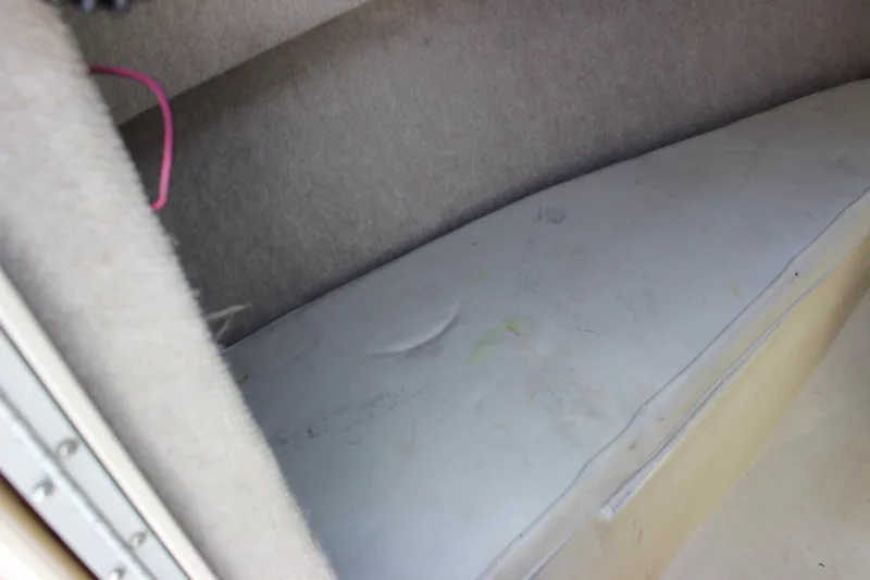 Slide: The Image of Interior cabin of a 1996 Parker 2110 Walkaround boat with cushioned seating. - 23