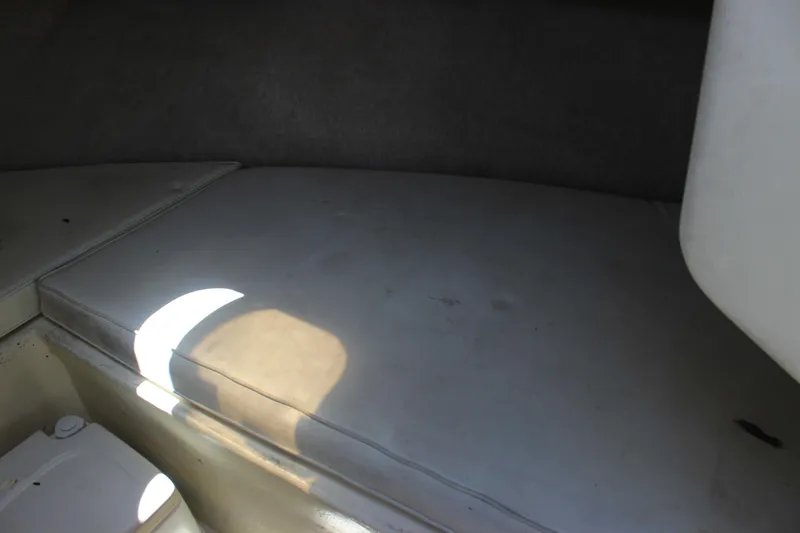 Slide: The Image of Interior cabin of a 1996 Parker 2110 Walkaround boat with cushioned seating. - 24