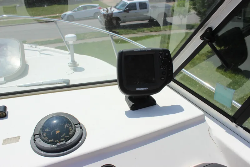 Slide: The Image of 1996 Parker 2110 Walkaround boat dashboard with compass and navigation system. - 30