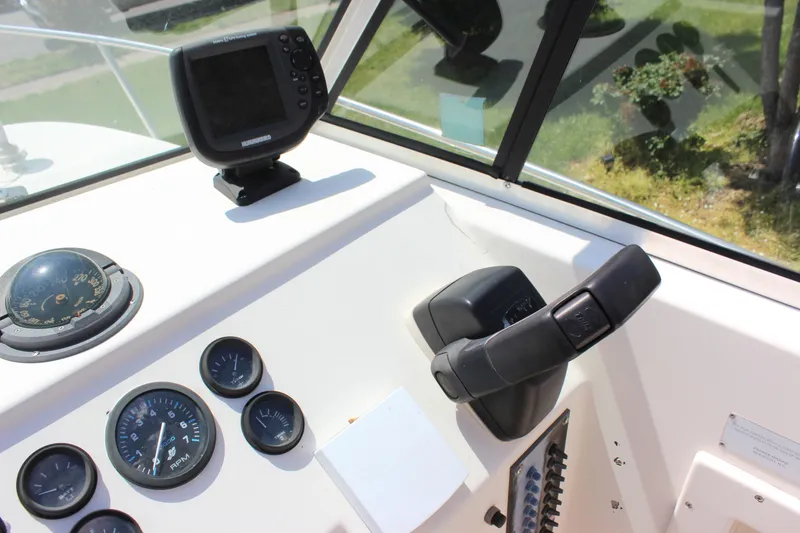 Slide: The Image of 1996 Parker 2110 Walkaround boat dashboard with steering wheel and gauges. - 31