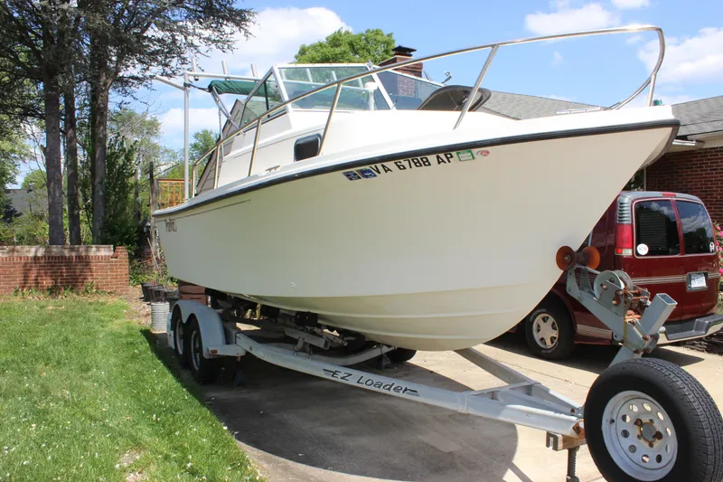 Slide: The Image of 1996 Parker 2110 Walkaround boat on trailer in driveway. - 35