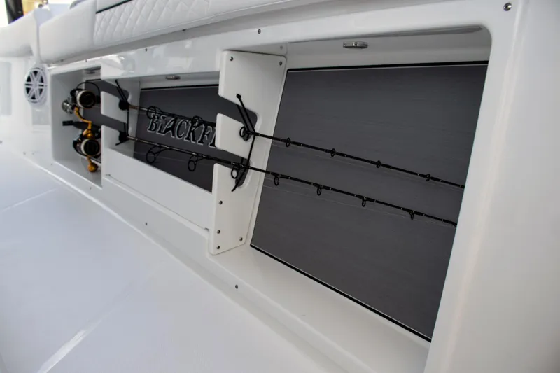 Slide: The Image of 2026 Blackfin 302 CC boat with integrated fishing rod storage. - 18