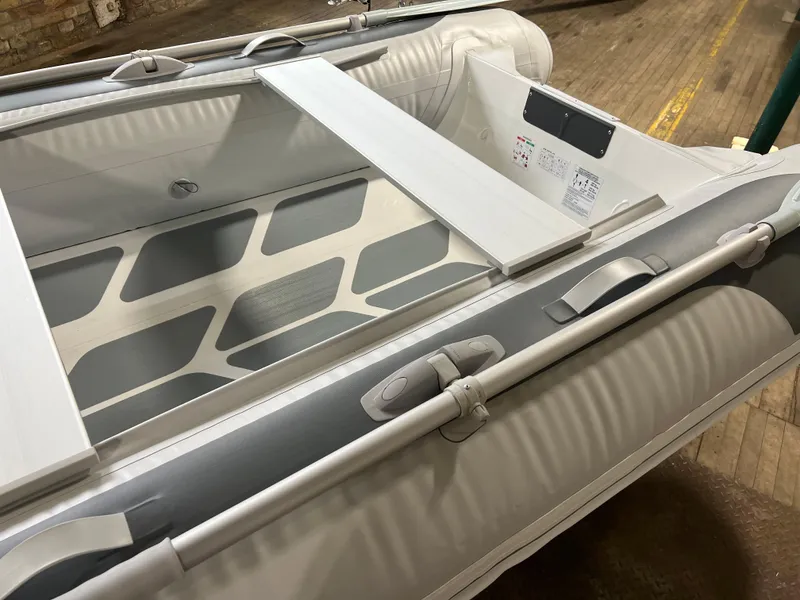 Slide: The Image of 2023 Gala A330D inflatable boat interior with wooden seats and oars. - 3