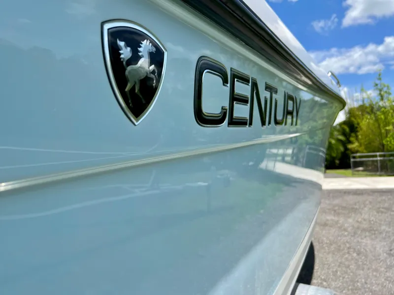 Slide: The Image of Close-up of 2005 Century 2600 Center Console boat with logo and clear sky. - 10