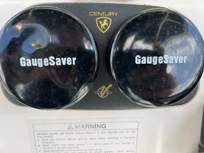 Slide: The Image of 2005 Century 2600 Center Console boat gauge covers with warning label. - 15