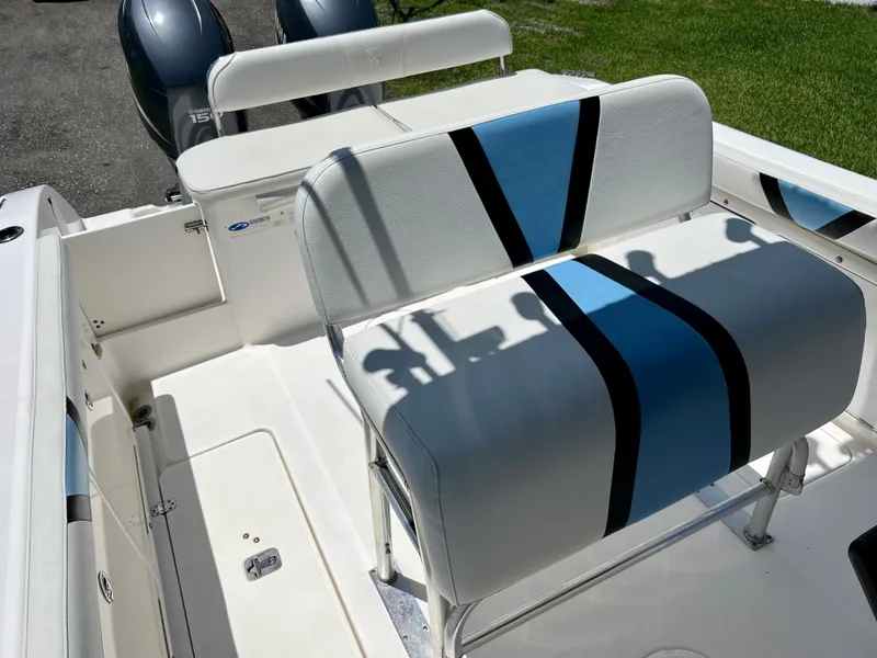 Slide: The Image of 2005 Century 2600 Center Console boat with dual engines and cushioned seating. - 26