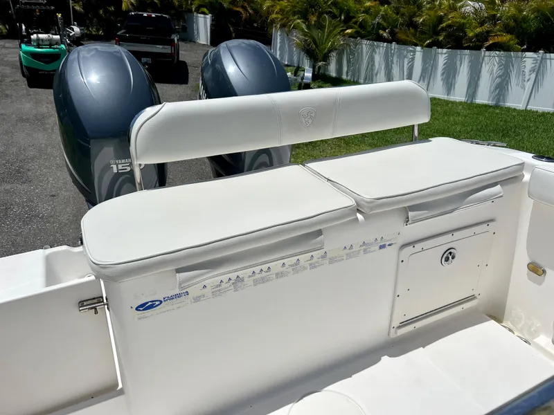 Slide: The Image of 2005 Century 2600 Center Console boat with twin Yamaha 150 engines, white cushioned seating. - 27