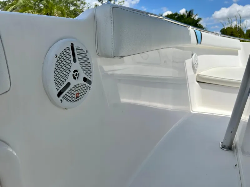 Slide: The Image of 2005 Century 2600 Center Console boat interior with white seating and speaker. - 28