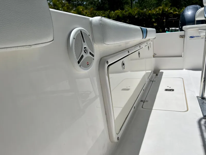 Slide: The Image of 2005 Century 2600 Center Console boat interior with storage compartments and speaker. - 29