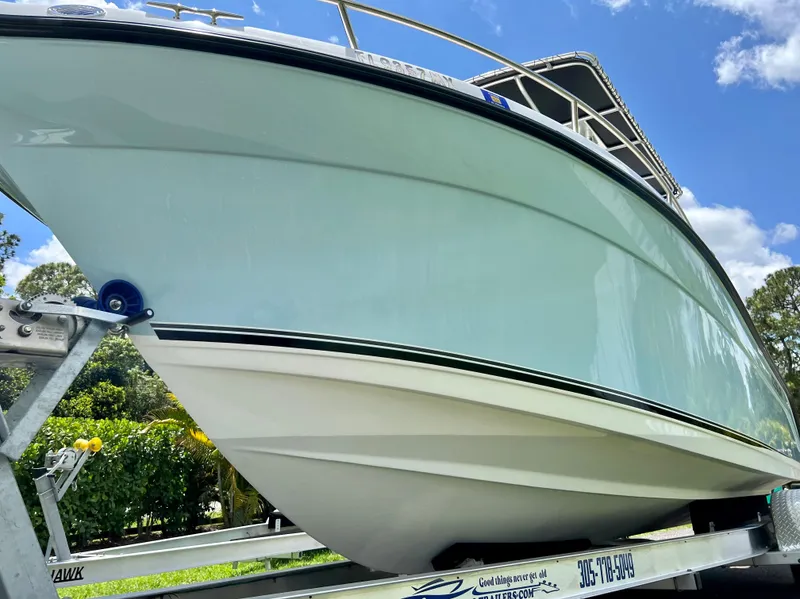 Slide: The Image of 2005 Century 2600 Center Console boat on a trailer, side view. - 4