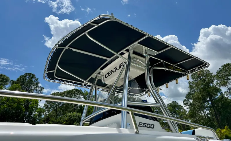 Slide: The Image of 2005 Century 2600 Center Console boat with T-top under a clear blue sky. - 5