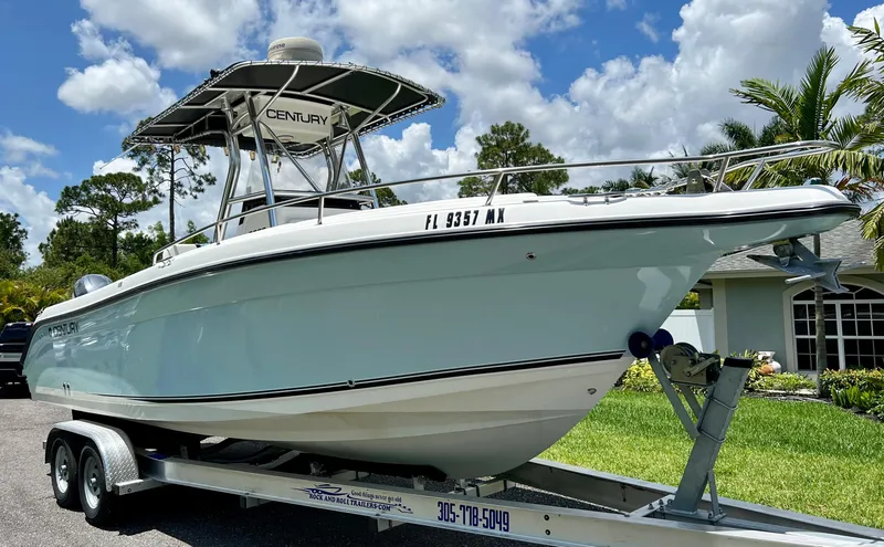 Slide: The Image of 2005 Century 2600 Center Console boat on a trailer, parked outdoors. - 7