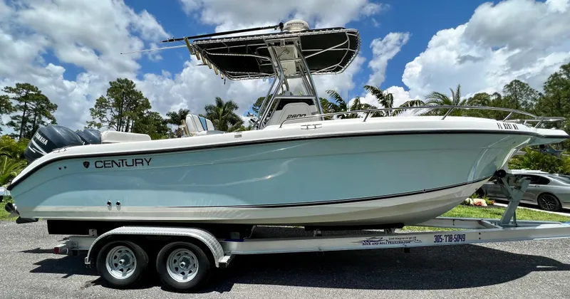 Slide: The Image of 2005 Century 2600 Center Console boat on a trailer under a blue sky. - 8