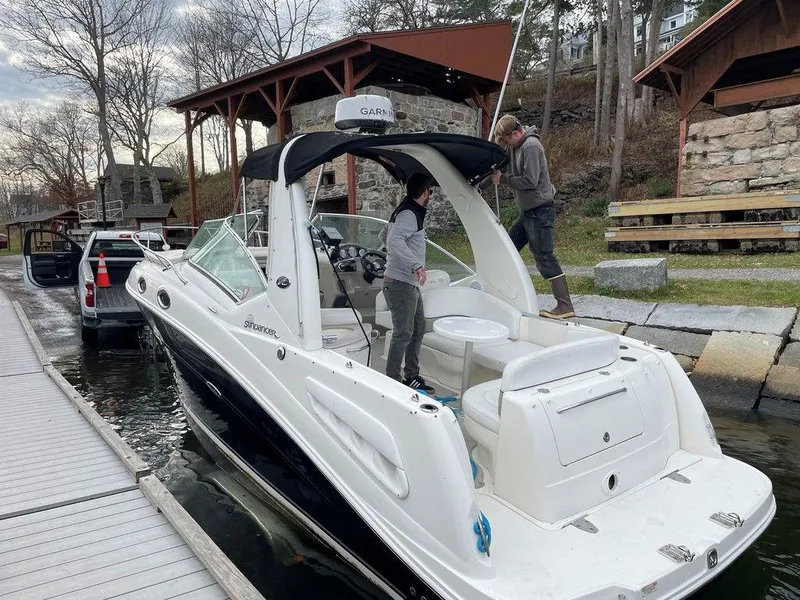 Slide: The Image of 2007 Sea Ray 260 Sundancer docked with two people onboard. - 10