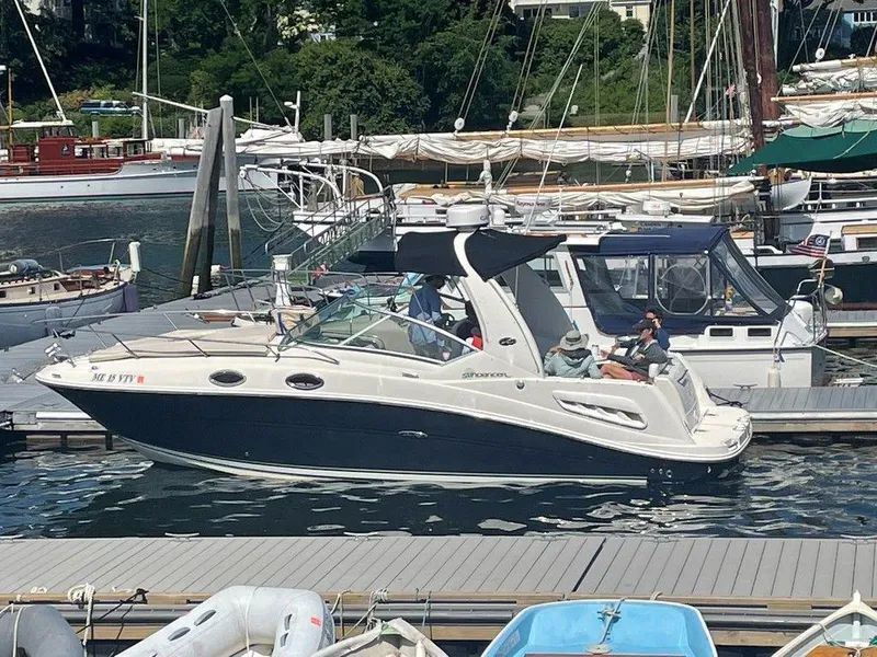 Slide: The Image of 2007 Sea Ray 260 Sundancer docked at a marina with people onboard. - 12