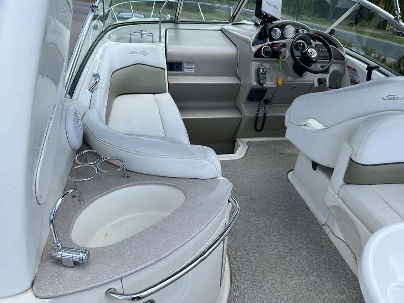 Slide: The Image of 2007 Sea Ray 260 Sundancer boat interior with helm, seating, and sink. - 2
