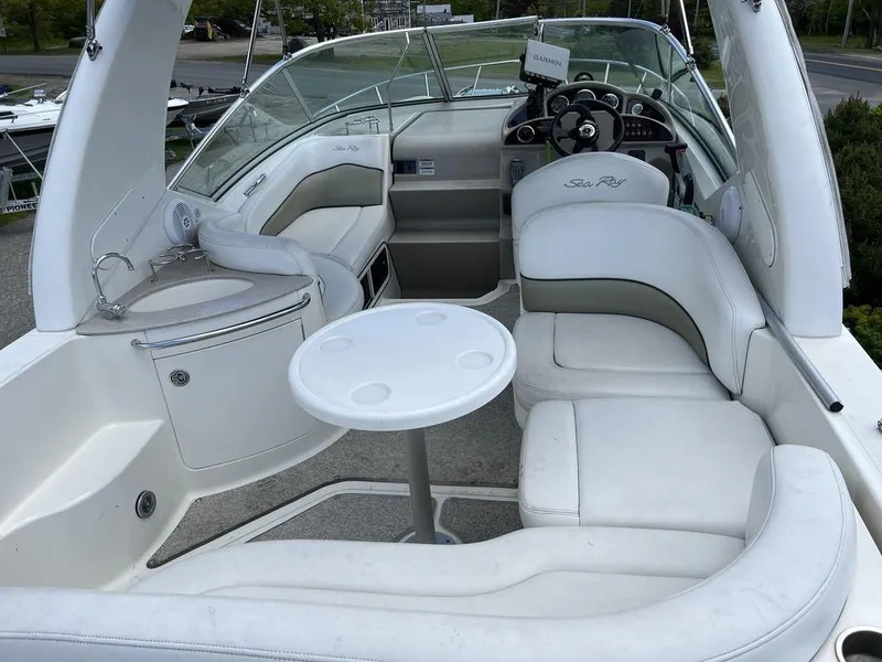 Slide: The Image of 2007 Sea Ray 260 Sundancer boat interior with white seating and table. - 3