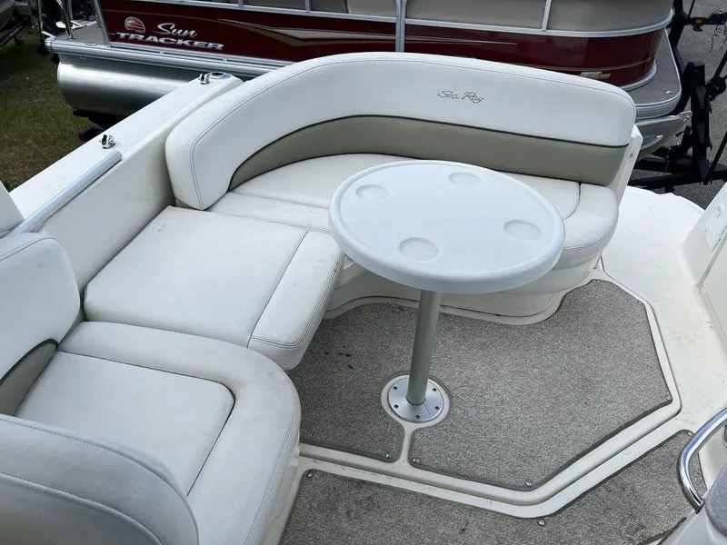 Slide: The Image of 2007 Sea Ray 260 Sundancer boat interior with white seating and table. - 4