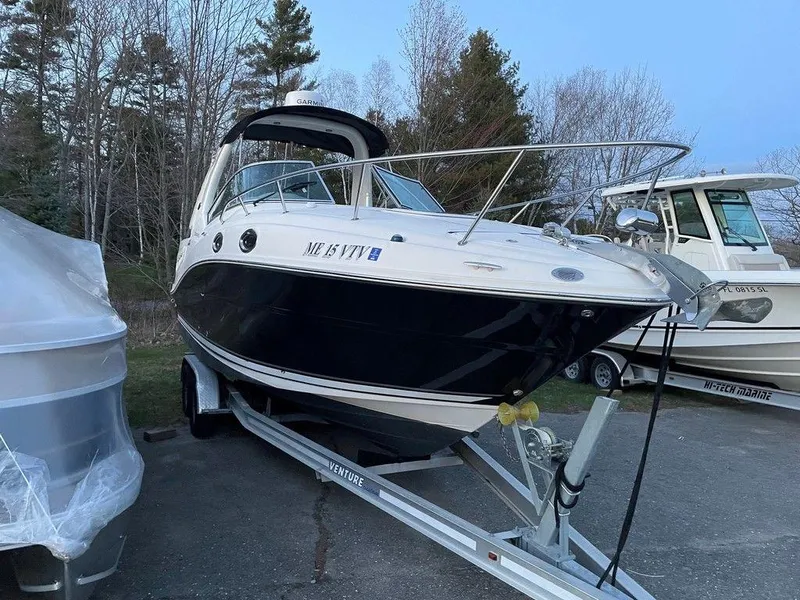 Slide: The Image of 2007 Sea Ray 260 Sundancer boat on a trailer in a parking lot. - 8