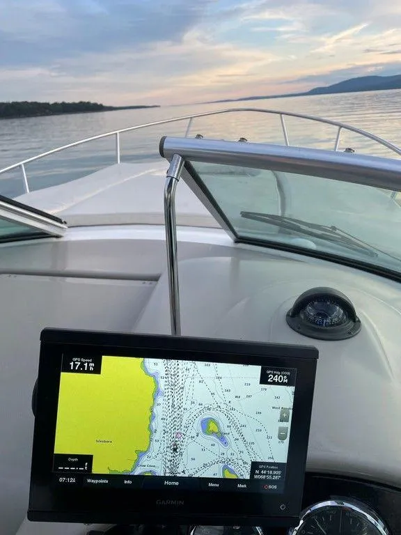 Slide: The Image of 2007 Sea Ray 260 Sundancer boat with navigation system on calm waters at sunset. - 9