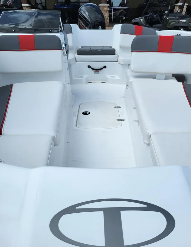 Slide: The Image of 2023 Tahoe T16 boat interior with white and red seating. - 2