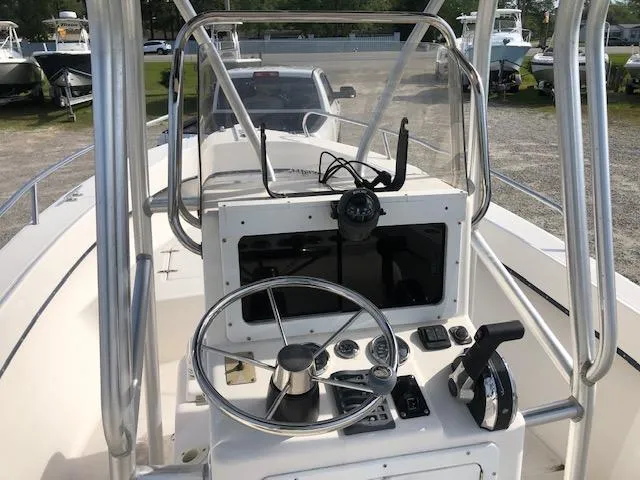 Slide: The Image of 2005 May-Craft 2000 CC center console boat dashboard with steering wheel and controls. - 11