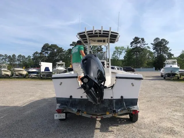 Slide: The Image of 2005 May-Craft 2000 CC boat with outboard motor on trailer in a boatyard. - 4