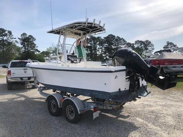 Slide: The Image of 2005 May-Craft 2000 CC boat on a trailer in a parking lot. - 5