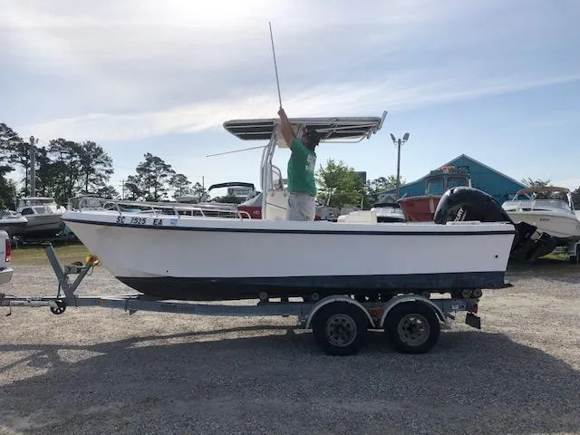 Slide: The Image of 2005 May-Craft 2000 CC boat on a trailer with a person standing inside. - 6