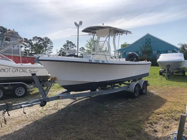 Slide: The Image of 2005 May-Craft 2000 CC boat on a trailer in a yard. - 7