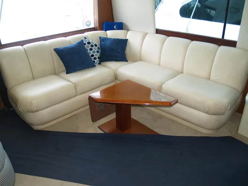 Slide: The Image of Luxurious 1999 Ocean Yachts interior with white leather seating and wooden table. - 13