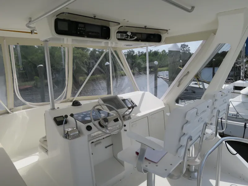 Slide: The Image of 1999 Ocean Yachts helm station with steering wheel, controls, and navigation equipment. - 3