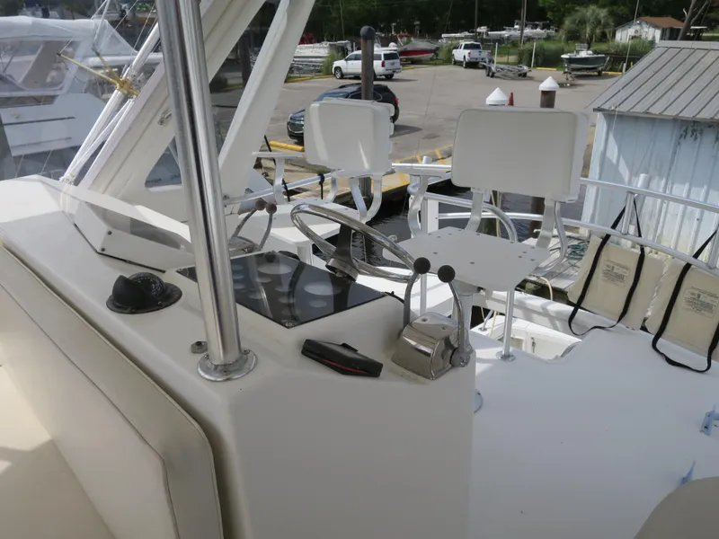 Slide: The Image of 1999 Ocean Yachts helm station with dual captain chairs and control panel. - 4