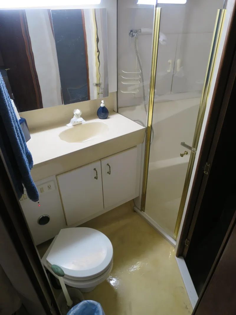 Slide: The Image of 1999 Ocean Yachts bathroom with shower, sink, and toilet. - 8