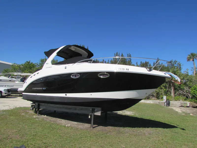 Slide: The Image of 2012 Chaparral Signature boat on display outdoors. - 1