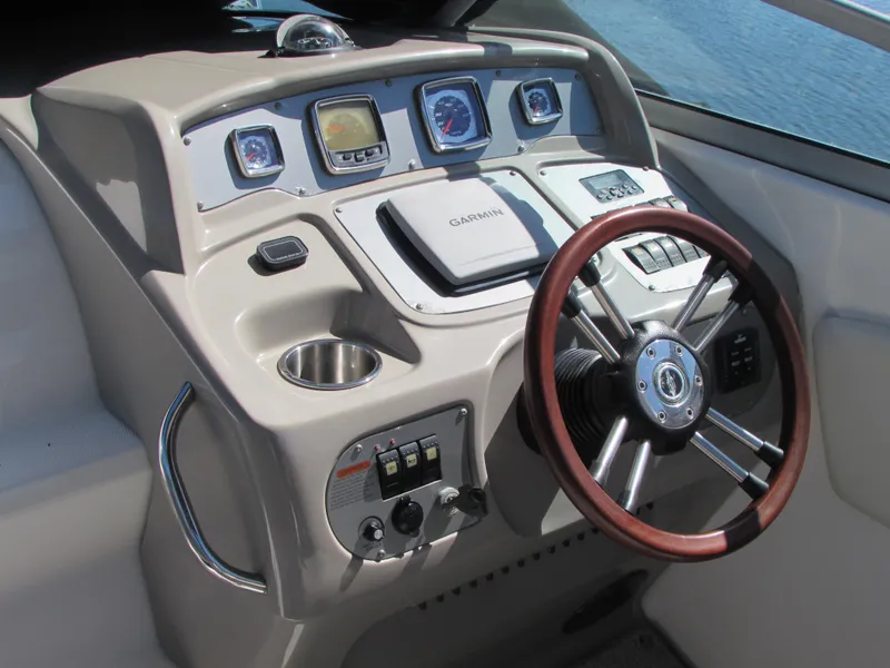 Slide: The Image of 2012 Chaparral Signature boat helm with Garmin navigation system and wooden steering wheel. - 12
