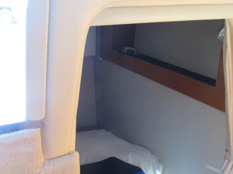 Slide: The Image of Interior cabin of 2012 Chaparral Signature boat with bed and storage shelf. - 14