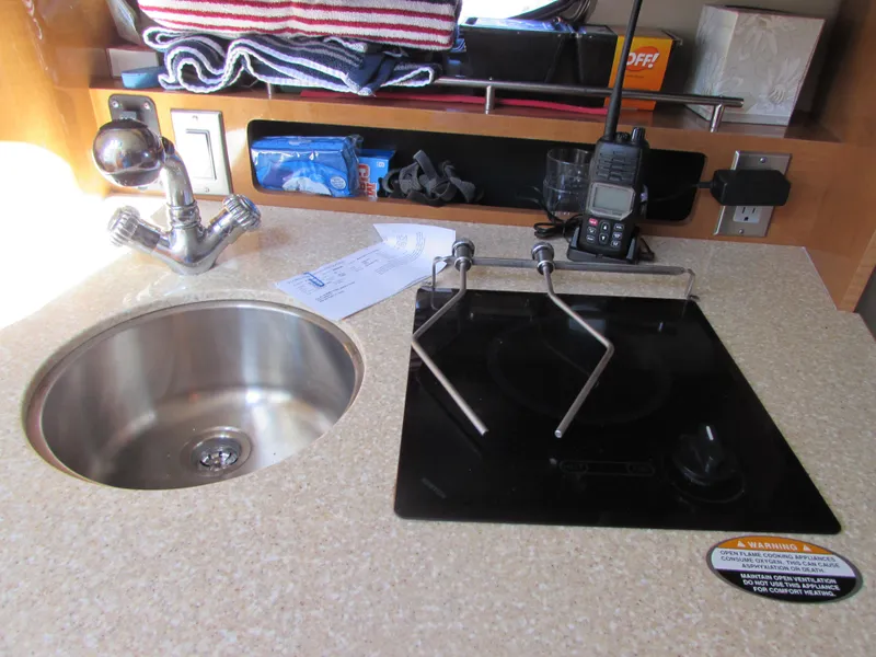 Slide: The Image of 2012 Chaparral Signature kitchen area with sink, stove, and radio. - 15