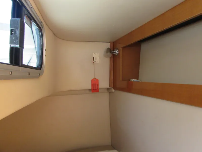 Slide: The Image of Interior cabin of 2012 Chaparral Signature boat with window and wooden shelf. - 18