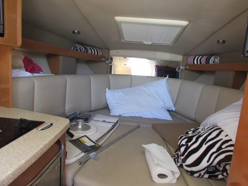 Slide: The Image of Interior cabin of 2012 Chaparral Signature boat with beige seating and bedding. - 20