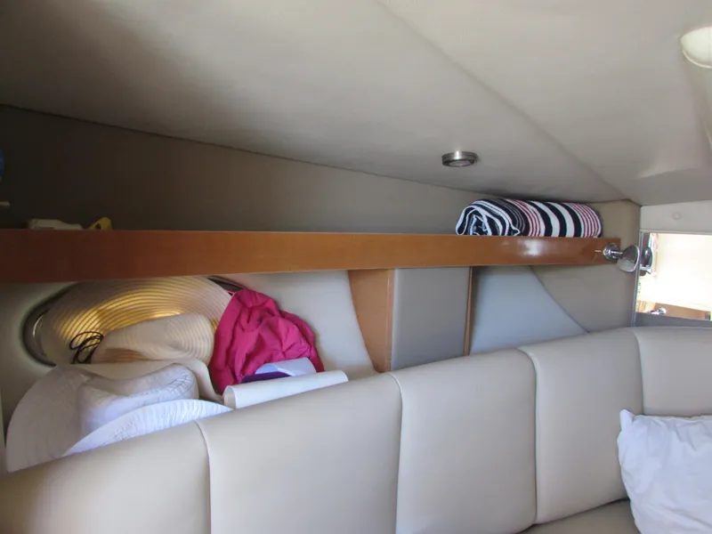 Slide: The Image of Interior cabin of 2012 Chaparral Signature boat with storage shelf and seating. - 22
