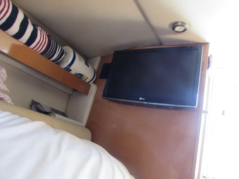 Slide: The Image of Interior of 2012 Chaparral Signature boat with LG TV and storage shelf. - 24